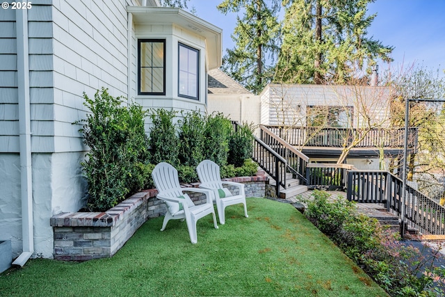 view of grassy yard with stairs and a deck