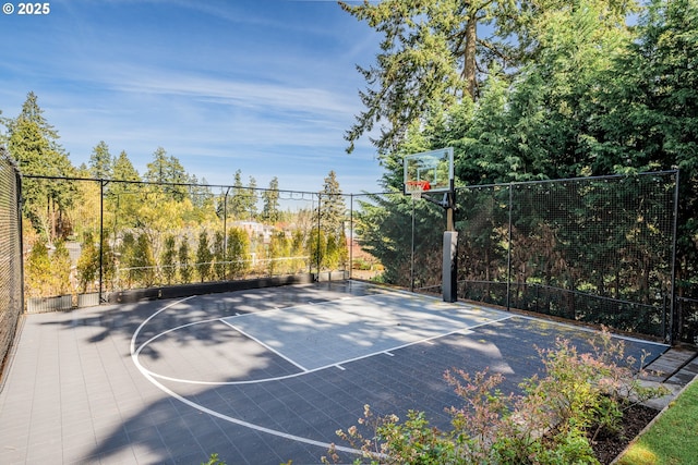 view of sport court with basketball court and fence