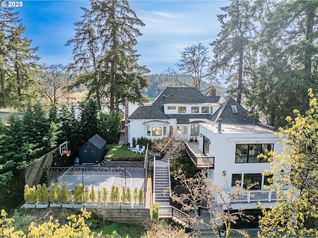 back of property featuring stairway and a chimney