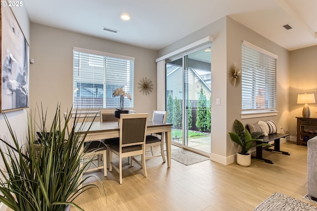 dining room with a wealth of natural light and light hardwood / wood-style flooring