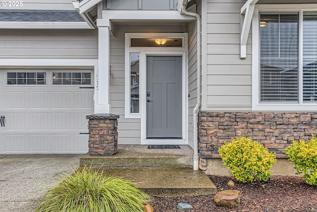 view of exterior entry with a garage