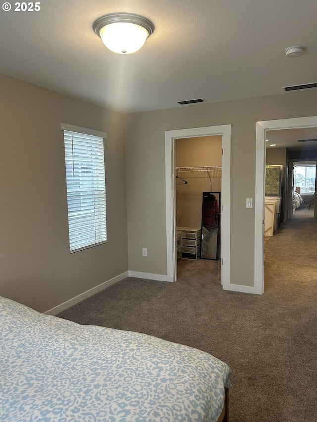 733 NW 178th Way, Ridgefield, WA 98642 - carpeted bedroom with a walk in closet, baseboards, a closet, and visible vents