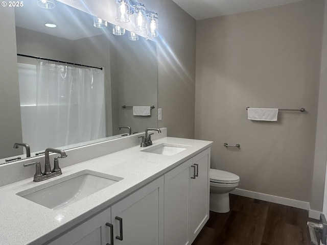 733 NW 178th Way, Ridgefield, WA 98642 - full bathroom with toilet, baseboards, a sink, and wood finished floors