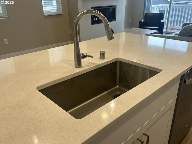 733 NW 178th Way, Ridgefield, WA 98642 - room details featuring white cabinets, light stone countertops, a sink, and dishwasher
