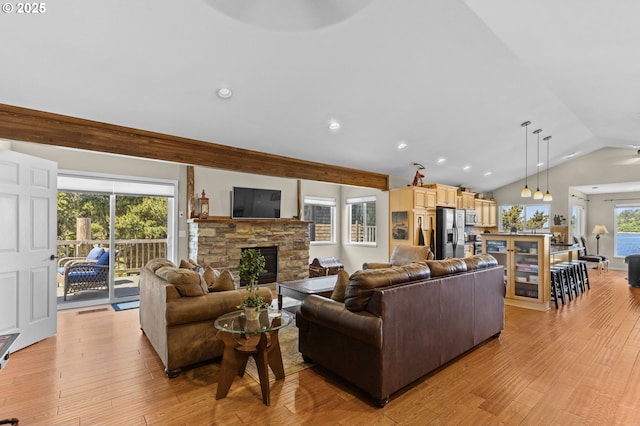 238 SW 27th St, Newport, OR 97365 - living room with a stone fireplace, vaulted ceiling, light wood-style floors, and recessed lighting