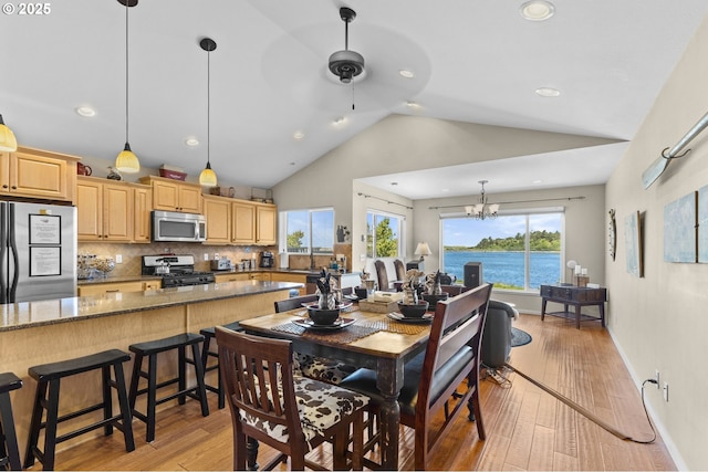 238 SW 27th St, Newport, OR 97365 - dining area featuring vaulted ceiling, light wood-style flooring, a chandelier, ceiling fan, and recessed lighting