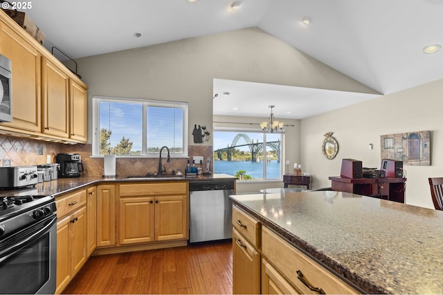 238 SW 27th St, Newport, OR 97365 - kitchen with stainless steel appliances, a sink, a chandelier, decorative backsplash, and dark wood finished floors
