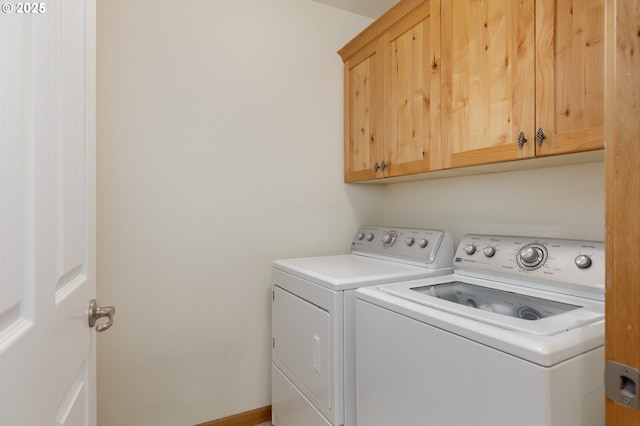 laundry room featuring cabinet space and washer and clothes dryer
