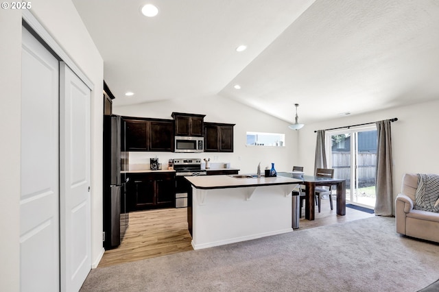 717 S 53rd Pl, Springfield, OR 97478 - kitchen featuring appliances with stainless steel finishes, open floor plan, vaulted ceiling, a sink, and light colored carpet