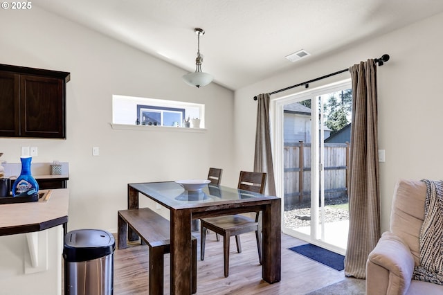 717 S 53rd Pl, Springfield, OR 97478 - dining room with lofted ceiling, light wood-style floors, and baseboards