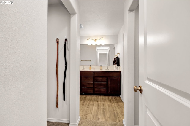 717 S 53rd Pl, Springfield, OR 97478 - full bath featuring double vanity, wood finished floors, baseboards, and a textured wall