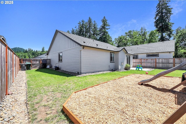 717 S 53rd Pl, Springfield, OR 97478 - rear view of house featuring board and batten siding, a playground, and a shingled roof