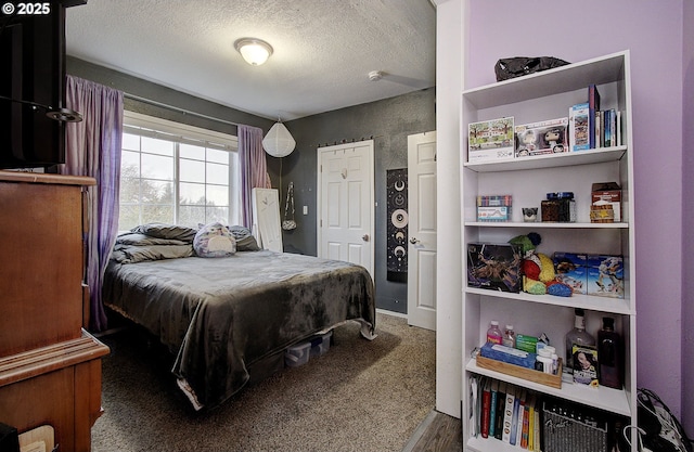 bedroom with carpet floors and a textured ceiling