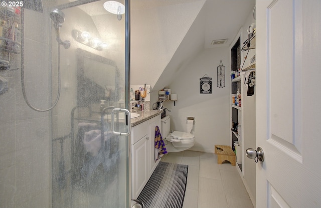 bathroom featuring vaulted ceiling, tile patterned flooring, vanity, an enclosed shower, and toilet