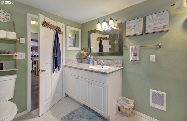 bathroom with vanity, tile patterned floors, and toilet