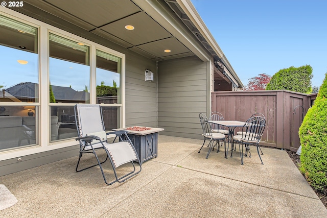 view of patio with outdoor dining space and fence
