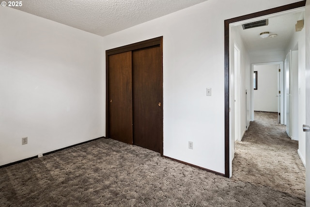 11613 Pacific Ct NE, Woodburn, OR 97071 - unfurnished bedroom with carpet flooring, a closet, and a textured ceiling