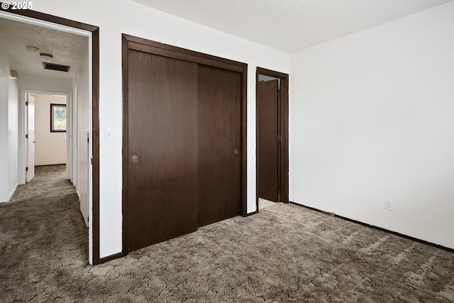 11613 Pacific Ct NE, Woodburn, OR 97071 - unfurnished bedroom featuring carpet, a textured ceiling, and a closet