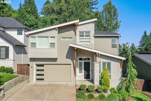 634 NE Province Ct, Camas, WA 98607 - contemporary house featuring stone siding, concrete driveway, and a garage
