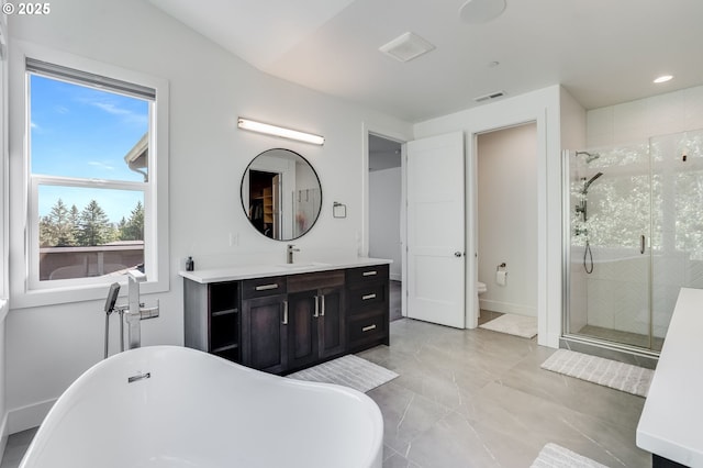 634 NE Province Ct, Camas, WA 98607 - bathroom featuring a freestanding bath, vanity, a shower stall, toilet, and recessed lighting