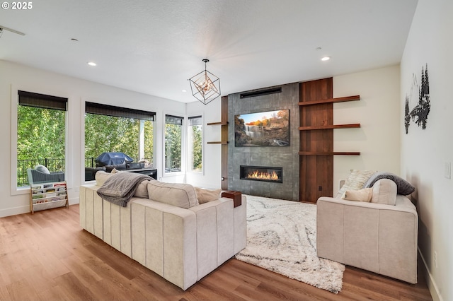 634 NE Province Ct, Camas, WA 98607 - living room featuring recessed lighting, a tiled fireplace, plenty of natural light, wood finished floors, and baseboards