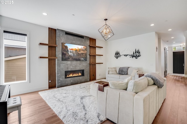 634 NE Province Ct, Camas, WA 98607 - living room with light wood finished floors, a tiled fireplace, and recessed lighting