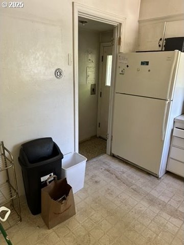 kitchen with light floors, light countertops, and freestanding refrigerator