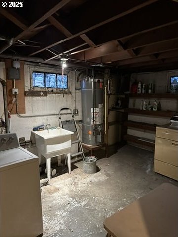 basement featuring washer / dryer, water heater, and a sink