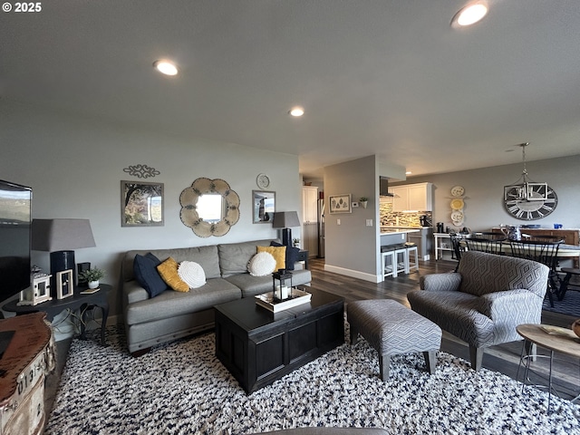 living room featuring baseboards, dark wood finished floors, and recessed lighting