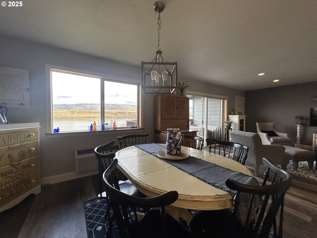 dining room with a wall mounted air conditioner, baseboards, dark wood-type flooring, and recessed lighting