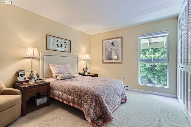 bedroom with light carpet and baseboards