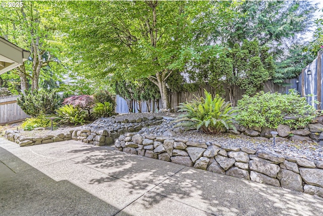 fenced backyard with a patio area