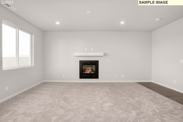 unfurnished living room with carpet flooring