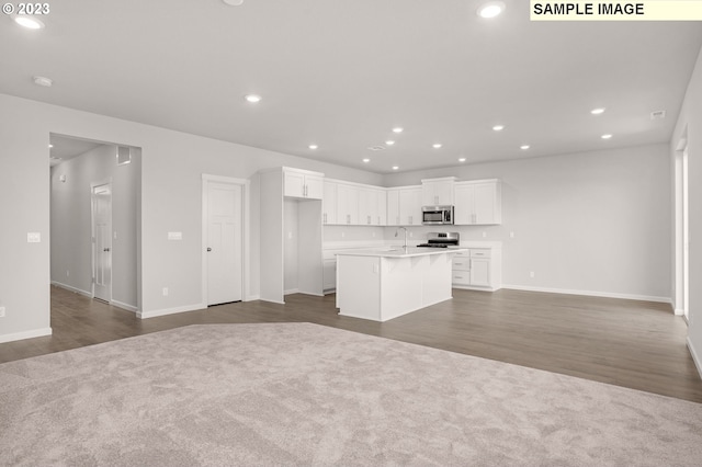 kitchen with sink, stainless steel appliances, dark hardwood / wood-style flooring, an island with sink, and white cabinets