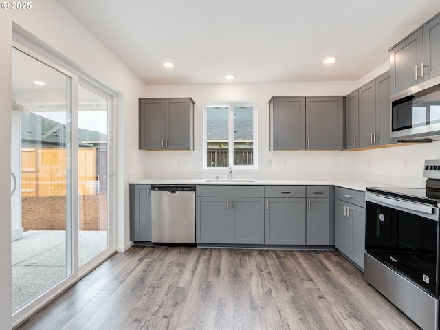 5905 NE 121st Way, Vancouver, WA 98686 - kitchen featuring recessed lighting, stainless steel appliances, light wood-type flooring, and gray cabinets