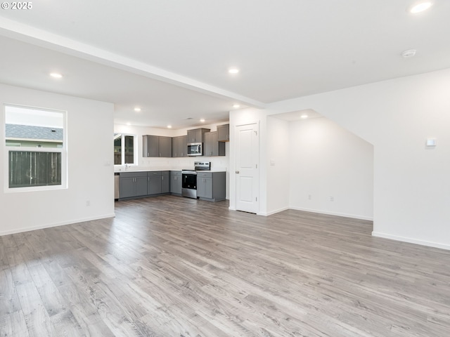 5905 NE 121st Way, Vancouver, WA 98686 - unfurnished living room featuring light wood-type flooring, baseboards, and recessed lighting