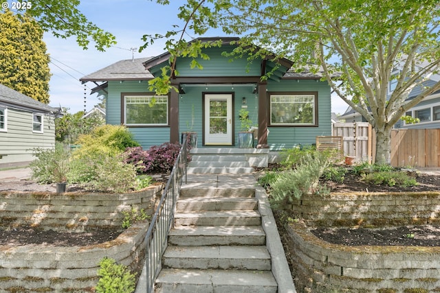 view of front of home featuring fence