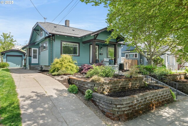 4134 N Concord Ave, Portland, OR 97217 - bungalow with an outdoor structure, roof with shingles, a chimney, driveway, and a detached garage