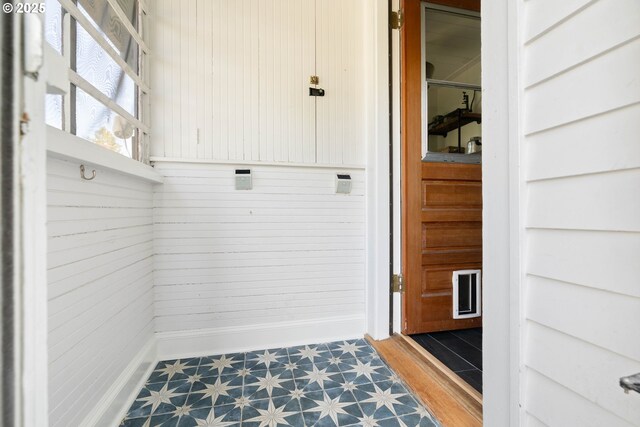 4134 N Concord Ave, Portland, OR 97217 - mudroom with tile patterned floors, wood walls, and baseboards