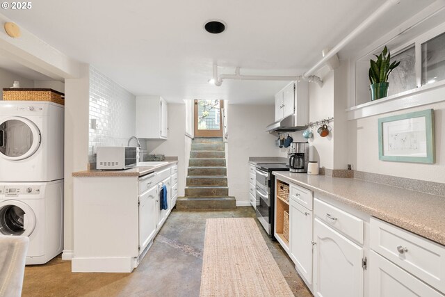 4134 N Concord Ave, Portland, OR 97217 - kitchen with stacked washer and dryer and white cabinetry