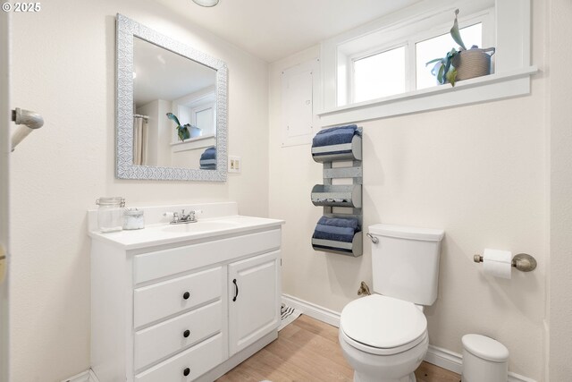 4134 N Concord Ave, Portland, OR 97217 - full bathroom featuring toilet, baseboards, wood finished floors, and vanity