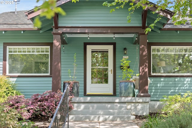 view of exterior entry with covered porch