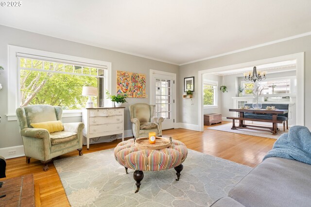 4134 N Concord Ave, Portland, OR 97217 - living room featuring baseboards, a chandelier, ornamental molding, and wood finished floors