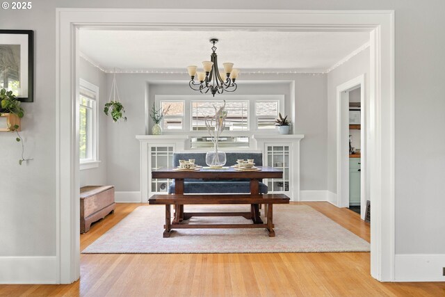 4134 N Concord Ave, Portland, OR 97217 - dining space featuring a notable chandelier, ornamental molding, and wood finished floors