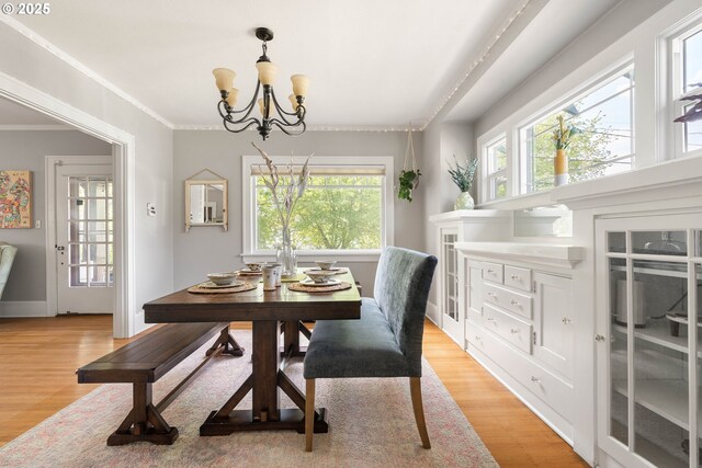 4134 N Concord Ave, Portland, OR 97217 - dining space featuring crown molding, a chandelier, and light wood-style floors