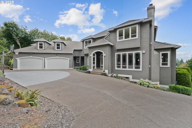 2350 SW Turner Rd, West Linn, OR 97068 - view of front of property with driveway, an attached garage, a chimney, and stucco siding
