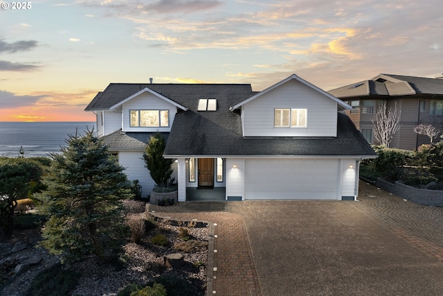 view of front of property with a water view and a garage