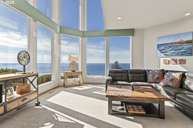 sunroom / solarium featuring a water view