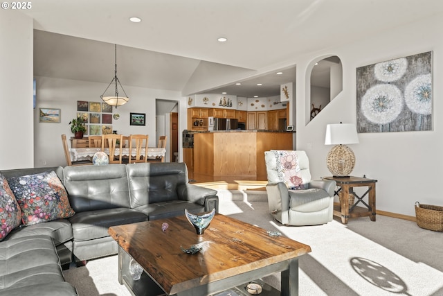 carpeted living room featuring lofted ceiling