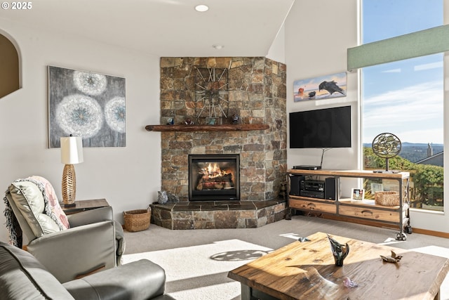 living room with carpet floors and a large fireplace